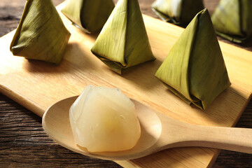 Sweet stuffed dough pyramid or Kanom Tian Kaew on wood plate on rustic table.Traditional food for...