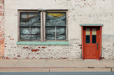 Old crumbling brick building with structural damage