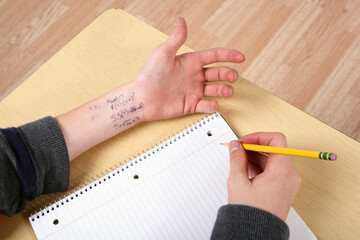 Cheating in school with formula written on wrist