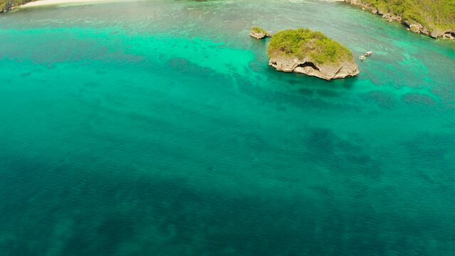 Clear turquoise water in a lagoon with rocky islands and corall reef from above Boracay, Philippines. Summer and travel vacation concept.