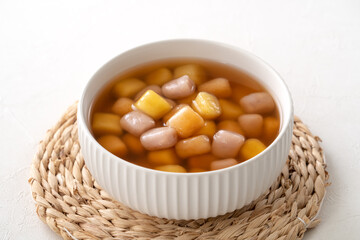 Delicious sweet taro ball soup in a white bowl for serving.