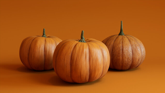 Seasonal background Image. Trio of Pumpkins on Orange color. Fall Concept.