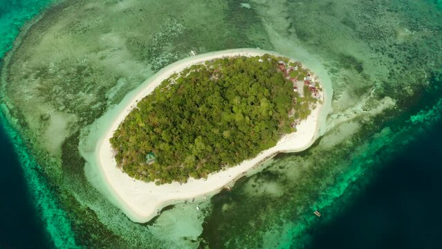 Beautiful beach on tropical island surrounded by coral reef, top view. Mantigue island. Small island with sandy beach. Summer and travel vacation concept, Camiguin, Philippines, Mindanao
