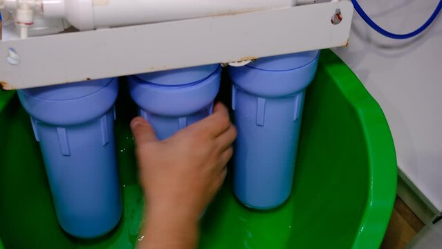 The plumber installs a new cartridge for the water filter
