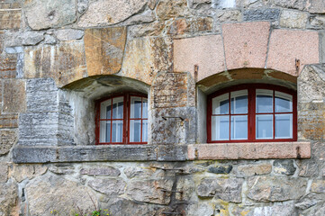 Windows and stone wall detail on historic building in the Oscarsborg Fortress, historic WW2 site in Norway

