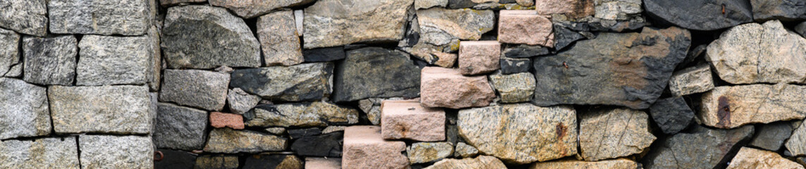 Pink stone stairs leading up a stone wall, as a graphic background
