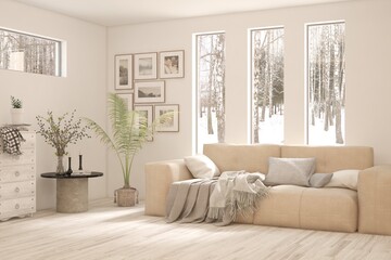 Fototapeta premium White living room with sofa and winter landscape in window. Scandinavian interior design. 3D illustration