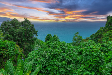 Colourful Skies Sunset over Head Laem Sing Beach in Phuket Thailand. This Lovely island waters are turquoise blue waters, lush green mountains colourful skies and beautiful views of Pa Tong Patong