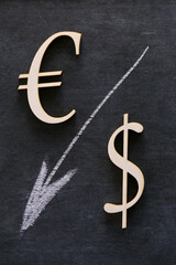 Falling currency rate. Euro and Dollar sign and a white down arrow on a black background.Dollar and Euro inflation. Financial Crisis.Exchange rate and Euro dollar Price increase.European economic
