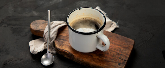 Cup of black coffee on dark background.