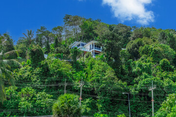 Villa Mansion in Phuket Mountains over looking Karon Beach lovely Skies Sunset over  Patong Pa Tong Beach in Phuket island Thailand. Lovely lush green mountains colourful skies