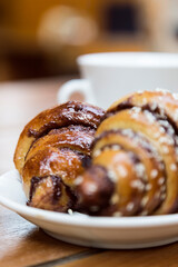 Delish chocolate croissant like rugelach and a cup of coffee in a restaurant.