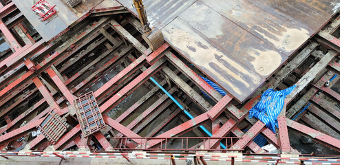 Building construction site in the city. Underground foundation for high-rise building. Metal...