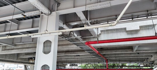 Landscape view of the  the sky train structure. Concrete structure and utility pipes underneath in...