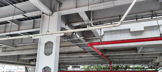 Fototapeta premium Landscape view of the the sky train structure. Concrete structure and utility pipes underneath in the city.