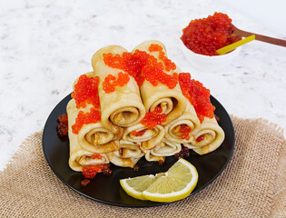 Pancakes with red caviar.
