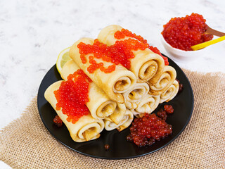 Pancakes with red caviar.