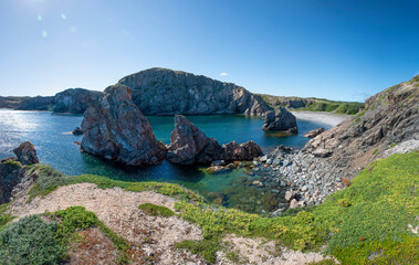 A panoramic view of Spiller's Cove near Twillingate, Newfoundland, as seen from the cliff at the side of it on a beautiful sunny day.