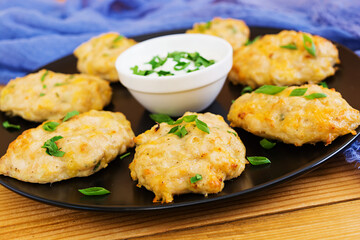 Chicken schnitzels on wooden background