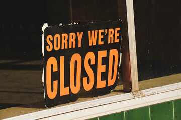 Old worn sorry we're closed sign in window