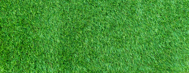 Fototapeta na wymiar Panorama of green artificial turf flooring texture