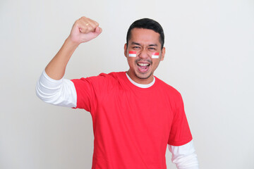Fototapeta premium Indonesian man showing excited expression during independence day celebration