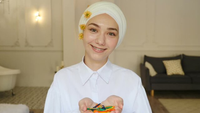 Portrait of young smiling muslim confident woman or teenage girl in dental braces on white teeth wearing traditional headscarf looking at camera. Orthodontic Treatment. self-ligating brackets. Full hd
