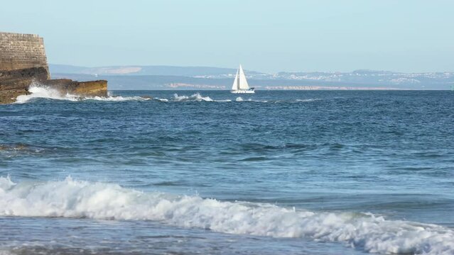 Tourist speed boat riding along a beautiful coast in Cascais province behind of fort saint Julian, Portugal