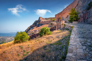 Old stone road to Acrocorinth fortress. Splendid morning scene of Greece, Europe. Traveling concept background.