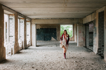 Art work on the theme of the war in Ukraine. A Ukrainian woman in national clothes, in a white dress and a bag in her hands, walks through an empty half-destroyed building.