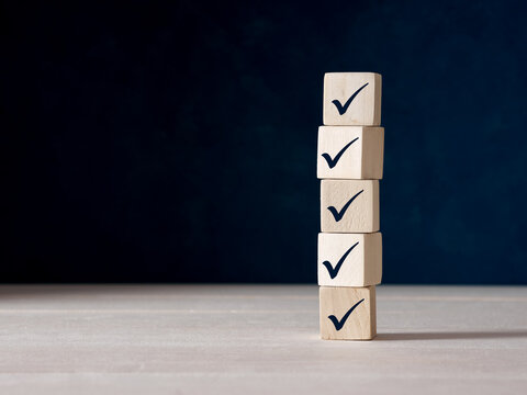 Checklist concept. Checkmark on ascending wooden blocks.