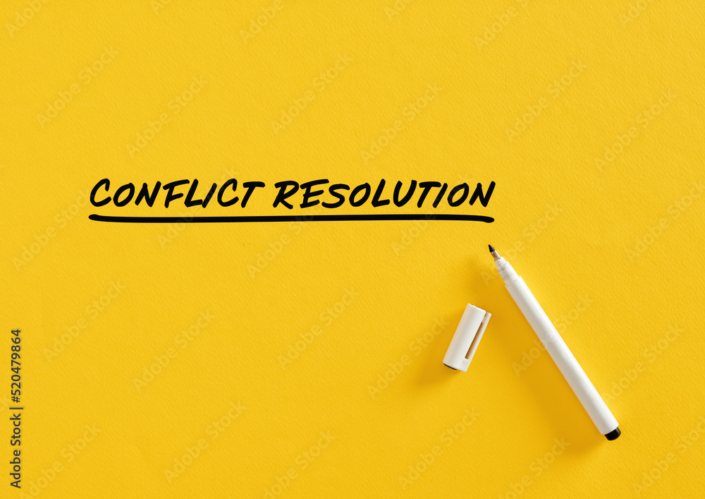 Poster conflict resolution message written on yellow background with felt tip pen.