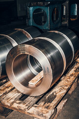 Cylindrical workpieces on a wooden pallet waiting for processing on machines