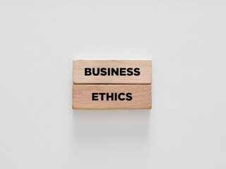 The word business ethics on wooden blocks on white background.