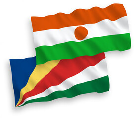 Obraz premium National vector fabric wave flags of Republic of the Niger and Seychelles isolated on white background. 1 to 2 proportion.