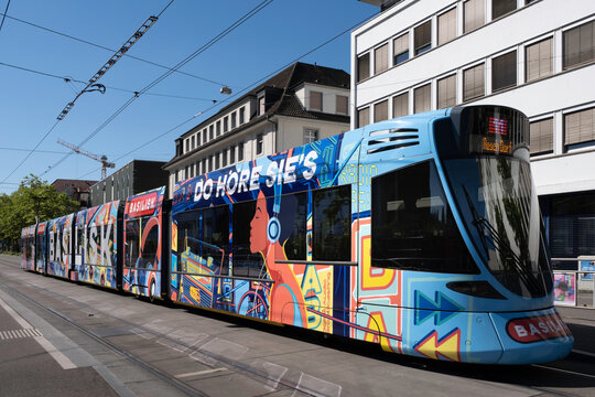 BASEL, SWITZERLAND - JULY 10 2022: Electric tram of the public transport company Basel tramway network running on the Hüningerstrasse in Basel