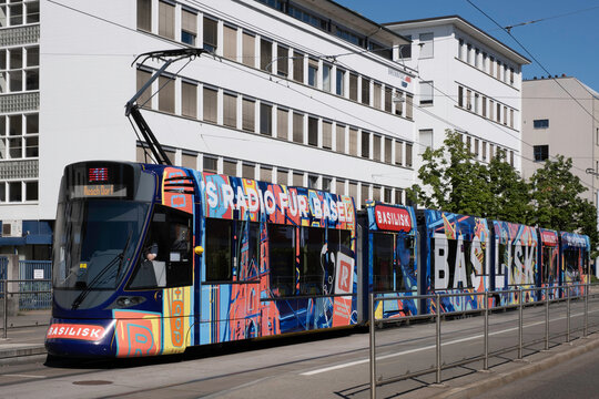 BASEL, SWITZERLAND - JULY 10 2022: Electric tram with overhead lines of the public transport company Basel tramway network running on the Hüningerstrasse in Basel