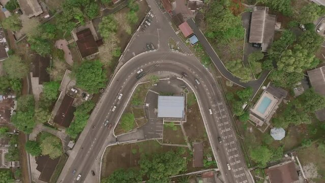 Aerial top down footage of a curved road in Freetown, Sierra Leone, Africa.