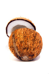 Coconut in two half and small pieces of coconut coconut oil and coconut water in a glass selective focus