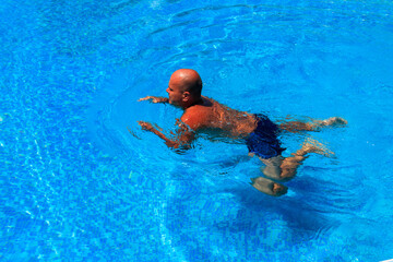 Handsome man relaxing in the swimming pool