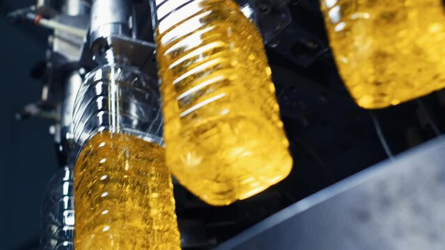 cooking oil production. Sunflower oil being bottled at a factory.  Oil Bottling factory. close up, 4K