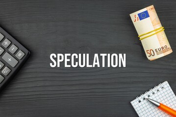 SPECULATION - word (text) and euro money on a wooden background, calculator, pen and notepad. Business concept (copy space).