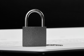 Padlock with a key on a laptop as a concept of protecting information in cyberspace