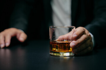 Businessmen in suits drinking whiskey