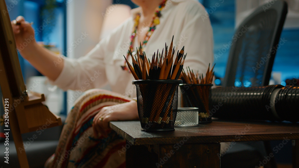 Poster pencils and artistic drawing tools on table to create artwork masterpiece on canvas with wooden ease