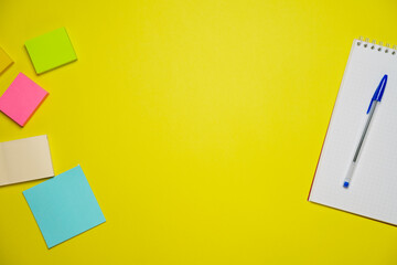 Top view photo open notepad ballpoint pen on yellow background with copy space. Minimalist flat...