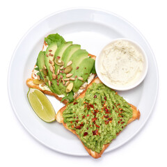 avocado and cream cheese toasts on a plate isolated on white background