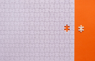 Jigsaw puzzle white color,Puzzle pieces grid,Success mosaic solution template,Horizontal on orange background copy space for text,Top view