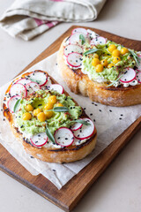 Bruschetta with guacamole, radish, white cheese, chickpeas and sage. Vegetarian food. Sandwich. Italian food.