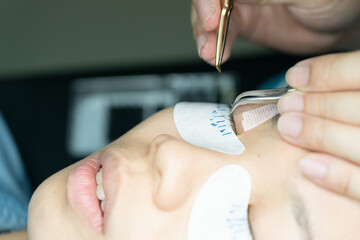 Eyelash extension procedure. woman eye with long eyelashes. lashes. close up, selected focus.